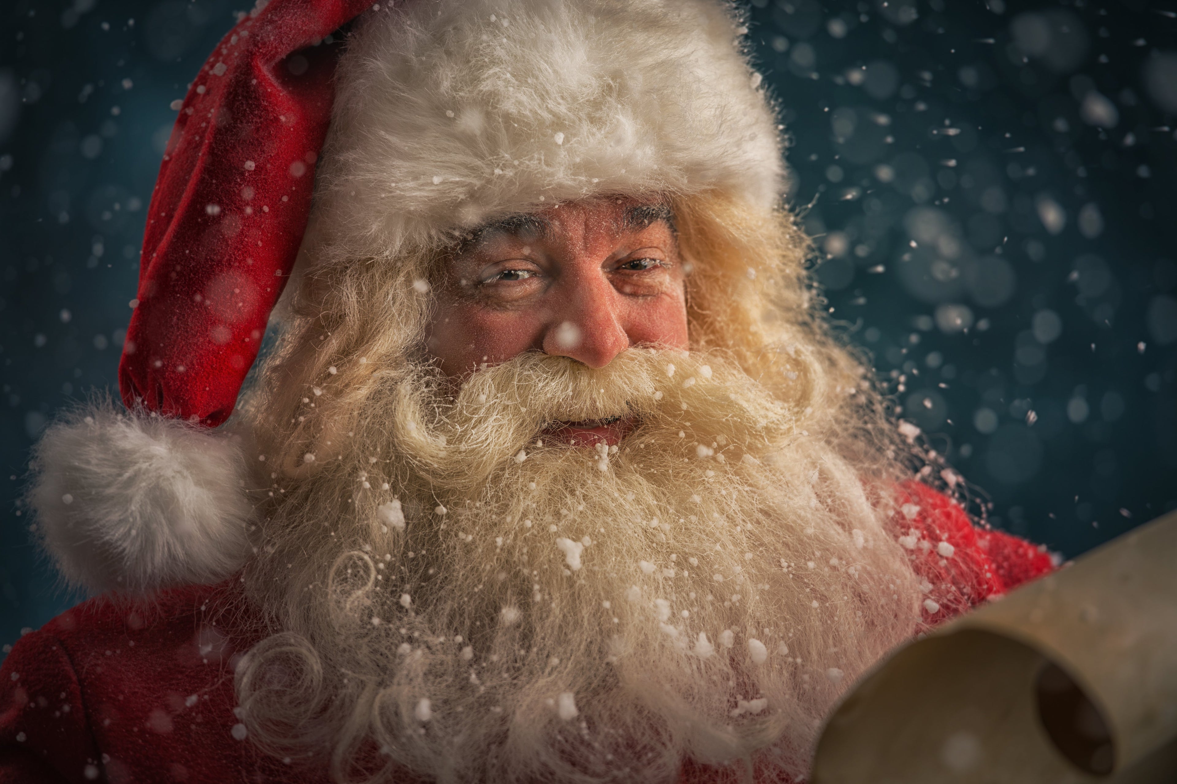 Santa Claus with Snow falling, reading a scroll